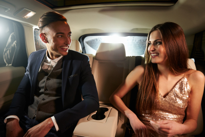 man and woman looking at each other inside the limousine